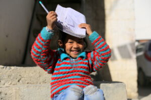 Little girl, trying to finish her homework while soaking in the sun. Humans of Spiti