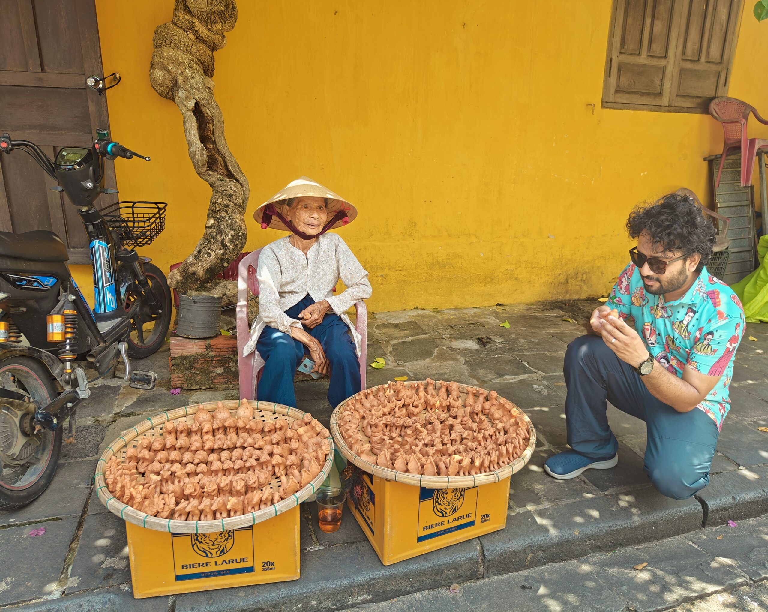 old lady selling clay toys in hoi an