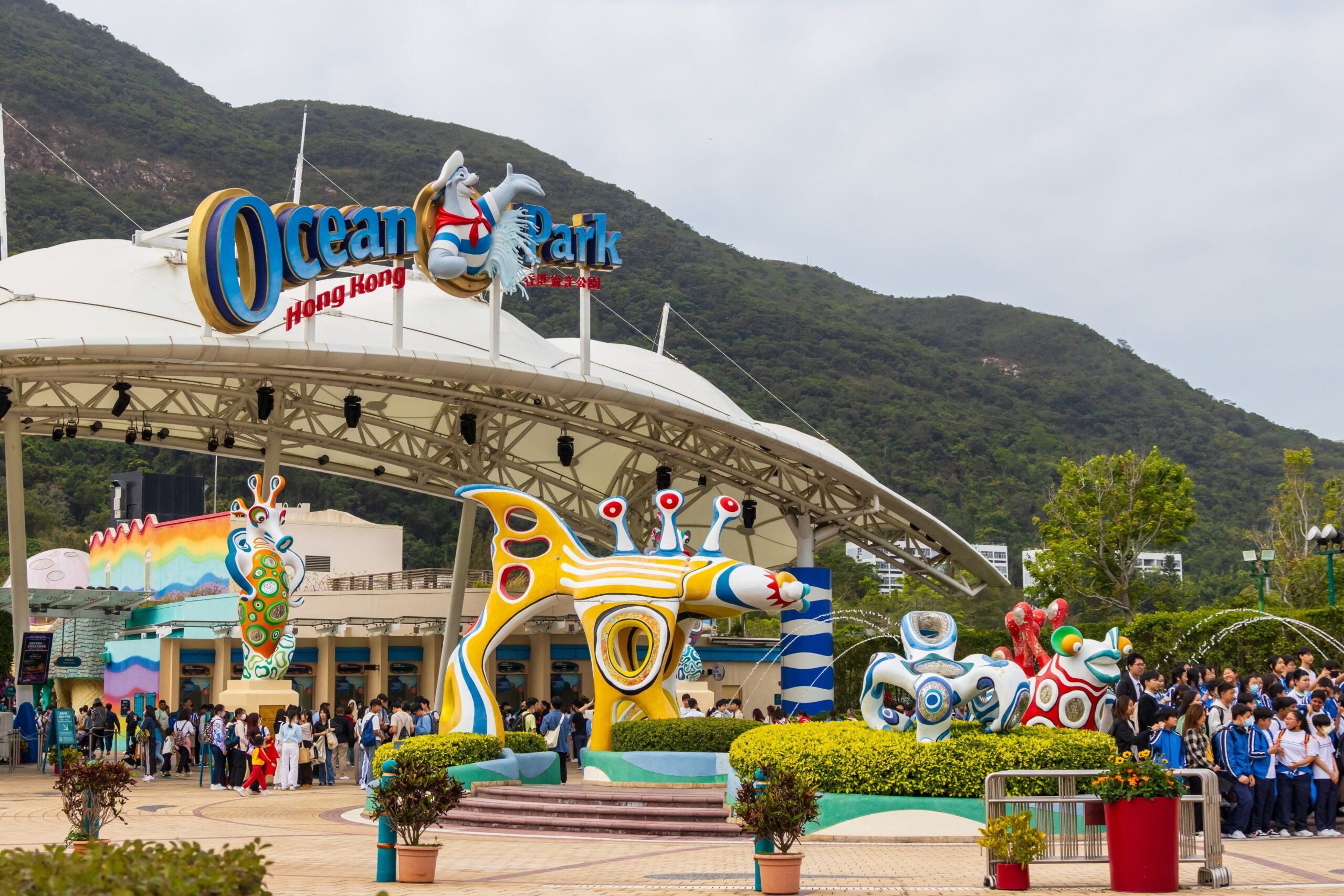 Ocean Park Hong Kong with a mountain in the background on a cloudy day.